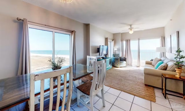 living area with ceiling fan and light tile patterned floors