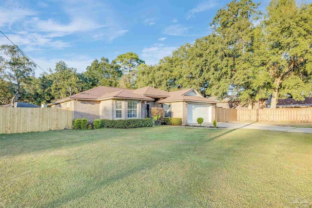 single story home featuring a garage and a front yard