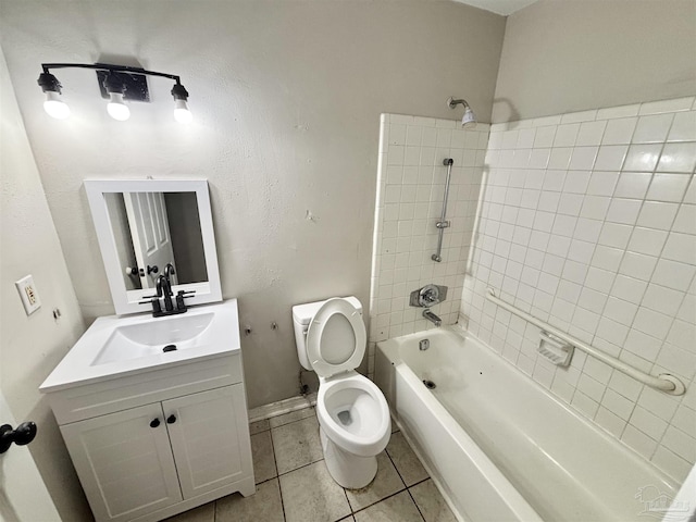 full bathroom with tiled shower / bath combo, vanity, tile patterned floors, and toilet