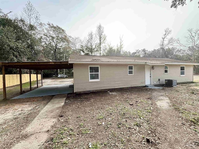 back of property featuring cooling unit and a carport