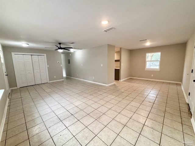 interior space with light tile patterned floors and ceiling fan