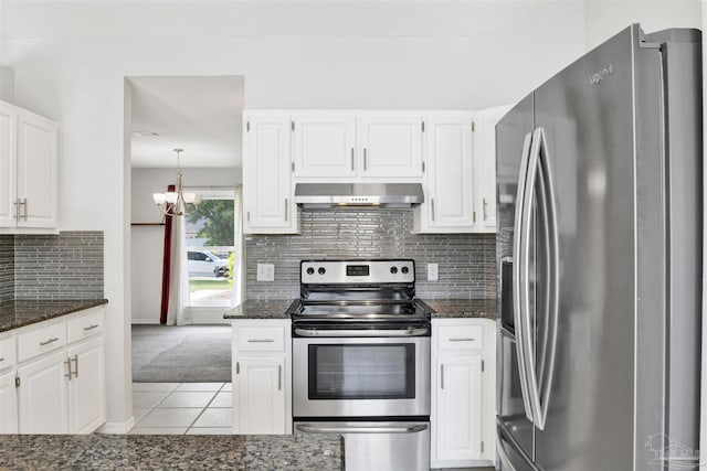 2252 Valle Escondido Dr, Pensacola, FL 32526 - kitchen with light tile patterned floors, wall chimney exhaust hood, white cabinets, and stainless steel appliances