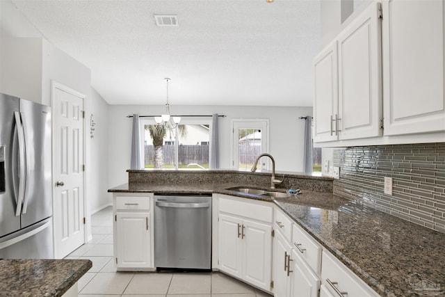 2252 Valle Escondido Dr, Pensacola, FL 32526 - kitchen featuring a sink, light tile patterned flooring, tasteful backsplash, visible vents, and appliances with stainless steel finishes