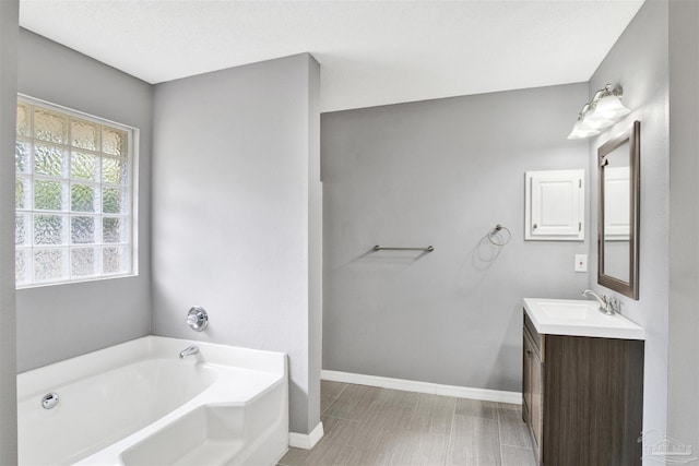 2252 Valle Escondido Dr, Pensacola, FL 32526 - bathroom featuring vanity, a bath, and baseboards
