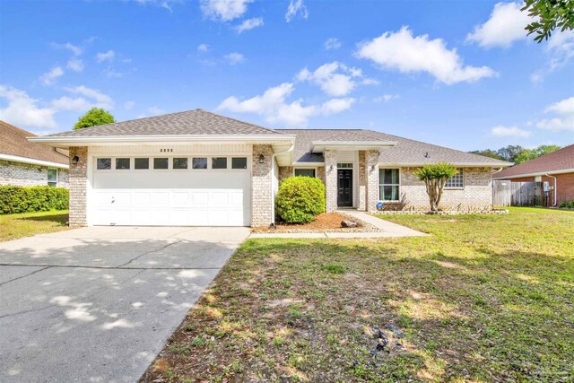 2252 Valle Escondido Dr, Pensacola, FL 32526 - single story home with concrete driveway, a front yard, an attached garage, and brick siding