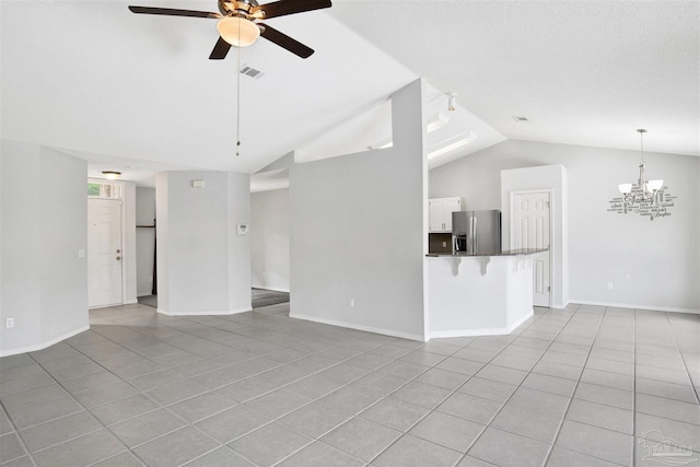 2252 Valle Escondido Dr, Pensacola, FL 32526 - unfurnished living room featuring lofted ceiling, visible vents, baseboards, light tile patterned flooring, and ceiling fan with notable chandelier
