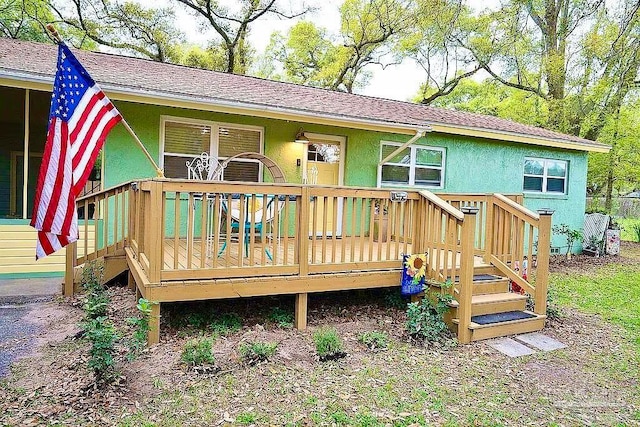 rear view of house featuring a deck