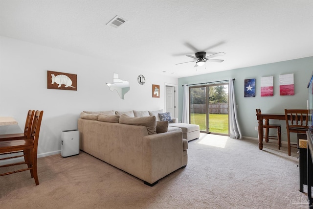 8743 Schooner Ln, Pensacola, FL 32507 - living area with light carpet, baseboards, visible vents, and a ceiling fan