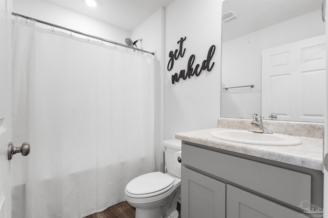 8743 Schooner Ln, Pensacola, FL 32507 - full bathroom featuring toilet, shower / tub combo with curtain, vanity, wood finished floors, and visible vents