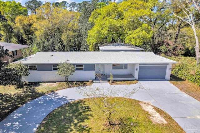 view of front of property featuring a garage and a front lawn