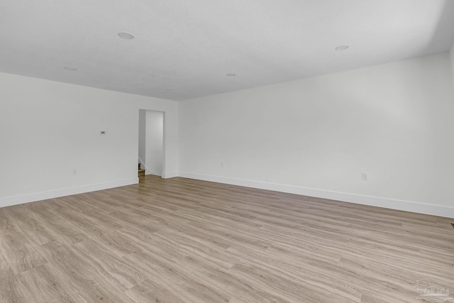 empty room with light hardwood / wood-style flooring