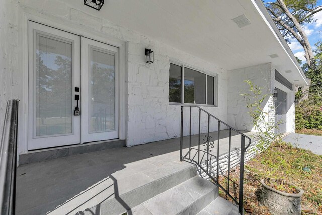 kitchen with light wood-type flooring, white cabinets, sink, decorative light fixtures, and stainless steel appliances