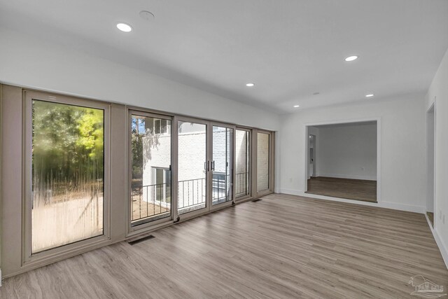 kitchen featuring appliances with stainless steel finishes, white cabinets, sink, and light wood-type flooring