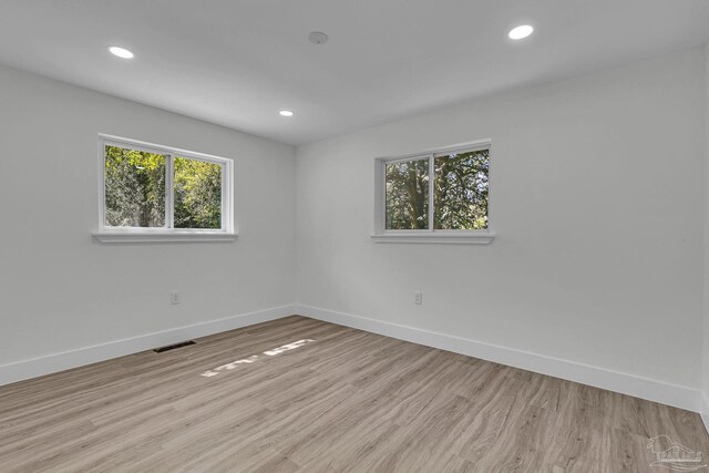 bathroom with hardwood / wood-style floors, toilet, walk in shower, and vanity