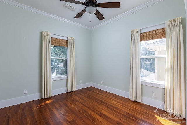 empty room featuring crown molding, plenty of natural light, visible vents, and dark wood-style flooring