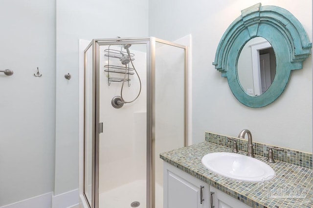 full bath featuring vanity and a shower stall