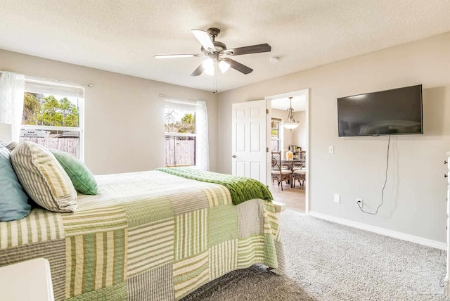 bedroom featuring ceiling fan, carpet, and a textured ceiling