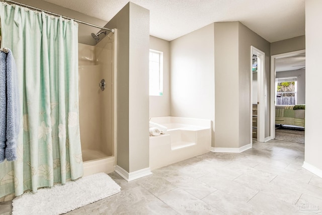 bathroom featuring independent shower and bath and a textured ceiling