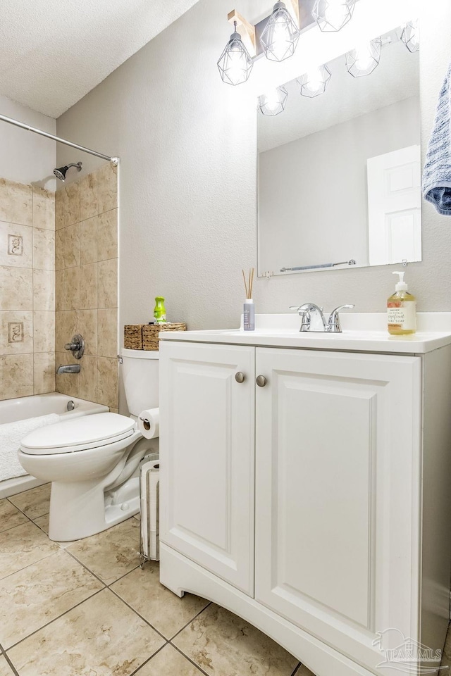 full bathroom with tiled shower / bath combo, vanity, tile patterned floors, and toilet