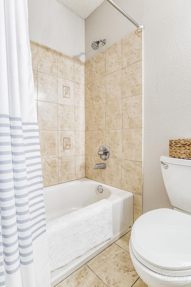 bathroom featuring a textured ceiling, shower / bath combination with curtain, tile patterned floors, and toilet