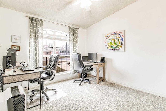 carpeted home office with vaulted ceiling and a textured ceiling