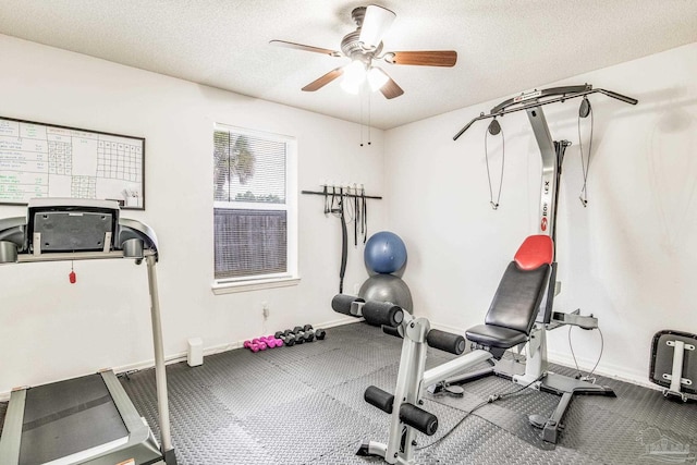 exercise area featuring ceiling fan and a textured ceiling