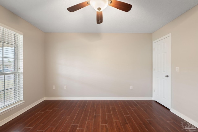 unfurnished room featuring a textured ceiling, ceiling fan, and dark hardwood / wood-style floors