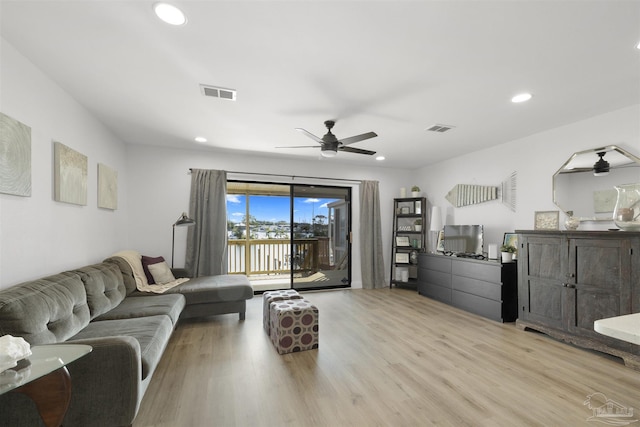 living room featuring light hardwood / wood-style flooring and ceiling fan