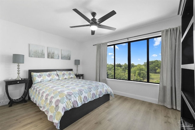 bedroom featuring ceiling fan and light hardwood / wood-style flooring