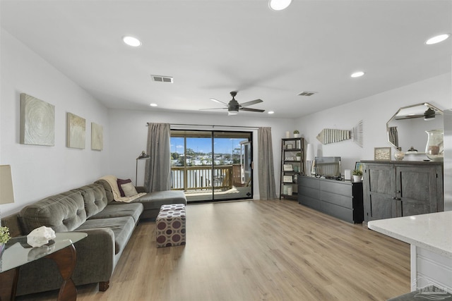 living room with ceiling fan and light wood-type flooring