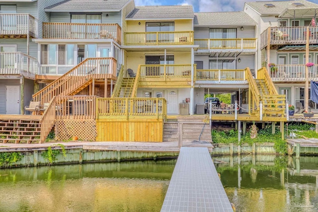 back of house with a deck with water view