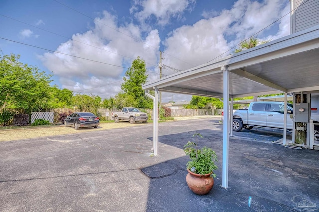 view of parking / parking lot featuring a carport