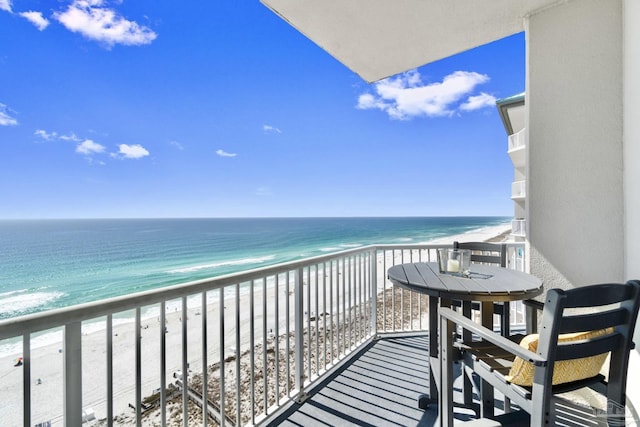 balcony featuring a beach view and a water view