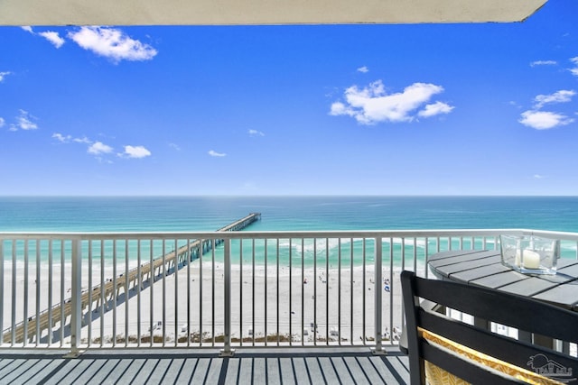 balcony with a view of the beach and a water view