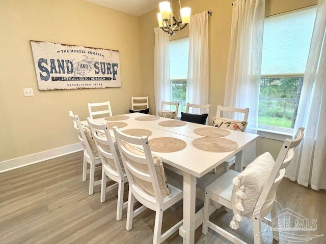 dining space featuring a chandelier, hardwood / wood-style floors, and plenty of natural light