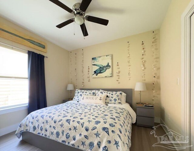 bedroom with ceiling fan and hardwood / wood-style floors