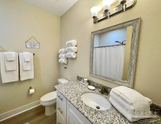 bathroom with hardwood / wood-style floors, vanity, lofted ceiling, a shower with curtain, and toilet