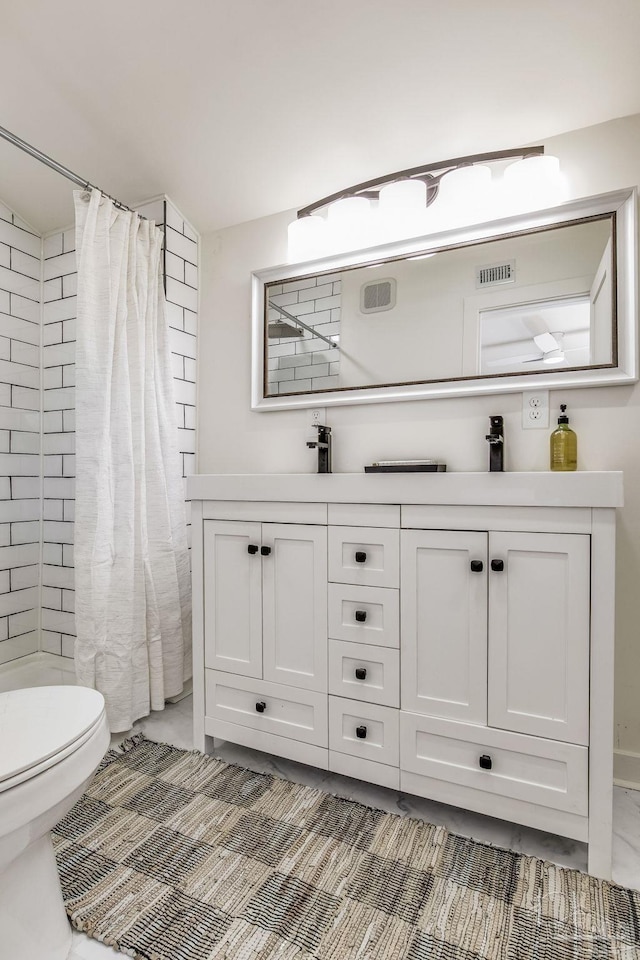 bathroom with vanity, toilet, and a shower with curtain