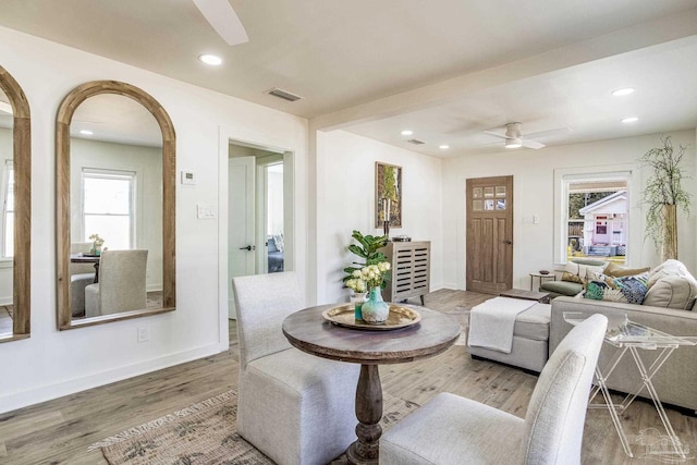 dining space with wood-type flooring, a wealth of natural light, and ceiling fan