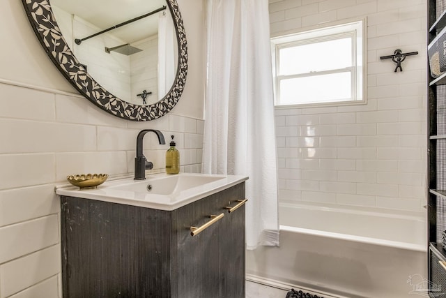 bathroom featuring shower / tub combo with curtain, vanity, and tile walls