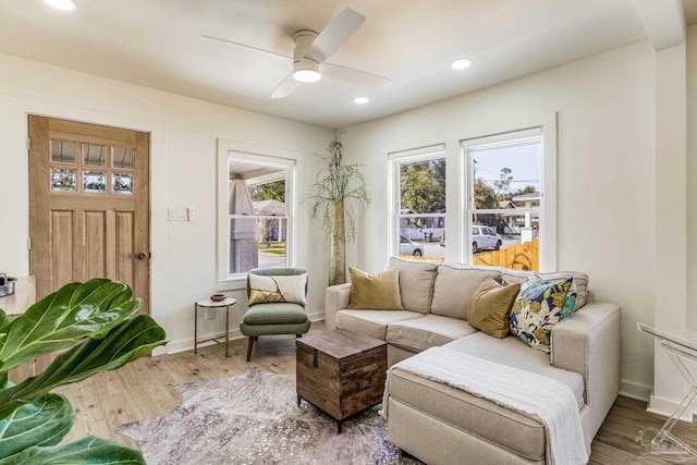 living area with hardwood / wood-style flooring and ceiling fan