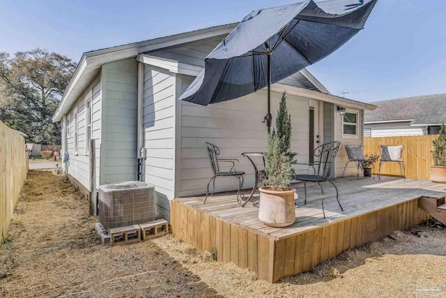 rear view of house featuring central AC unit and a deck