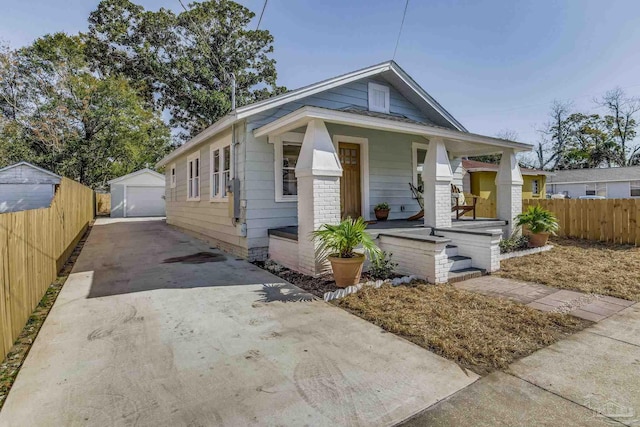 bungalow featuring an outbuilding, a porch, and a garage