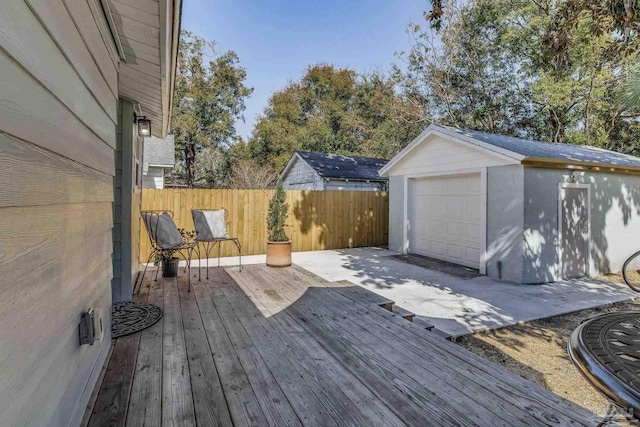 wooden deck featuring an outbuilding and a garage