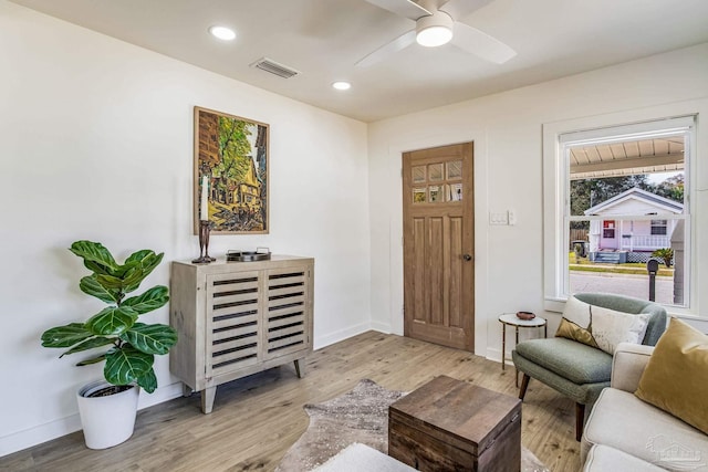 living room featuring ceiling fan and light wood-type flooring