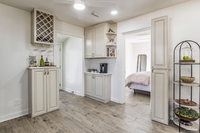 kitchen featuring ceiling fan and light hardwood / wood-style floors