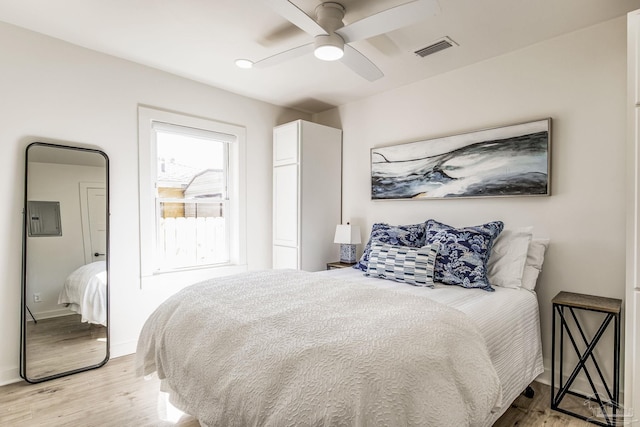 bedroom with ceiling fan and light hardwood / wood-style floors