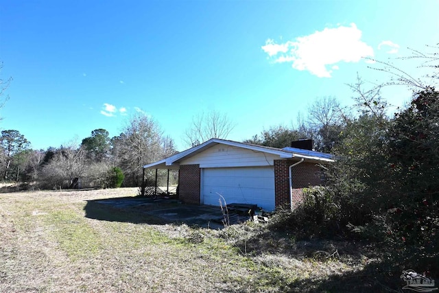 view of property exterior with a garage and brick siding