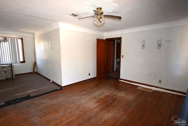 unfurnished room featuring visible vents, hardwood / wood-style floors, a ceiling fan, a textured ceiling, and baseboards