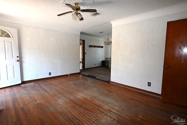 empty room with baseboards, hardwood / wood-style floors, visible vents, and a ceiling fan